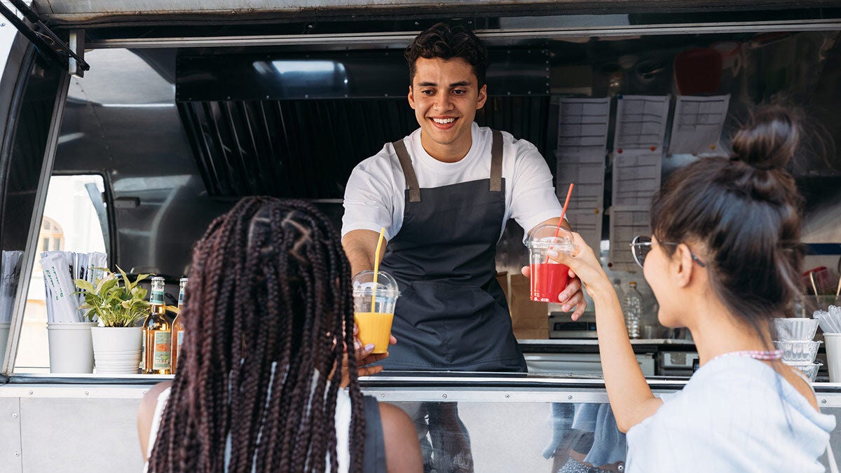 a man serving drinks to a woman