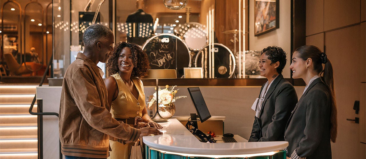 HRH-Couple Checking In At A Hotel